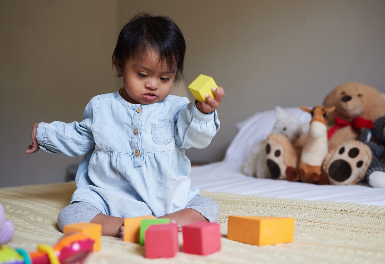 Baby with Down Syndrome Playing with Blocks 